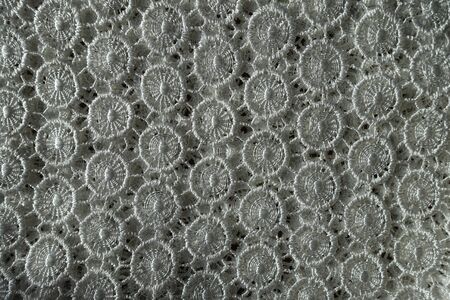View of ivory white crochet lace fabric from above
