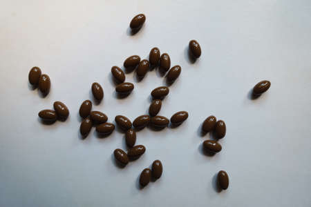 Multiple brown softgel capsules of vitamin D3 from aboveの写真素材