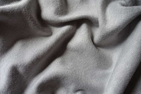 Soft folds on simple gray jersey cotton fabricの写真素材