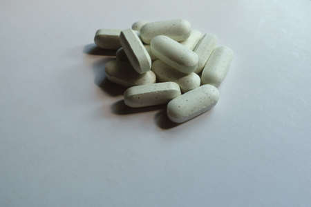Group of greenish white caplets of kelp dietary supplement