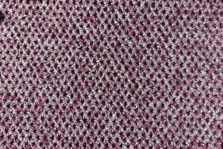Thick pink, grey and white woolen fabric with diamonds pattern from above