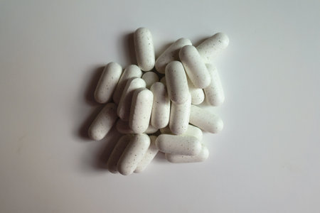 View of heap of white caplets of kelp dietary supplement from above