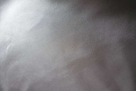 Surface of glossy gray polyester satin fabric from above
