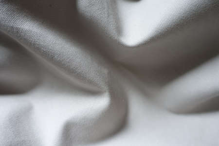 Soft folds on simple unprinted  light gray cotton fabricの写真素材