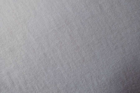 Surface of simple white cotton jersey fabric from above