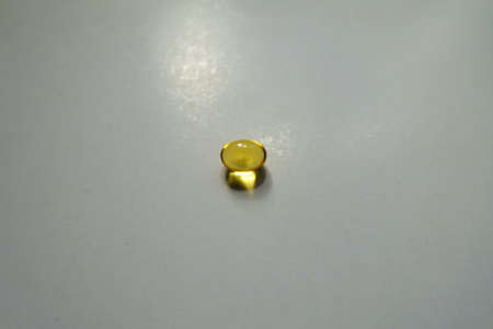 Translucent yellow softgel capsule of vitamin A (retinyl palmitate)の写真素材