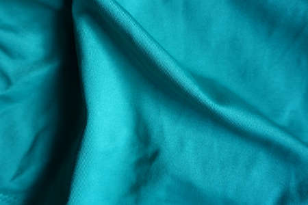 Folded blue green polyester fabric from aboveの写真素材