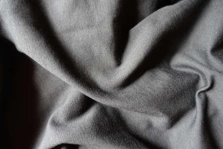 simple unprinted black cotton jersey fabric in soft folds
