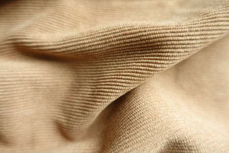Close shot of light brown corduroy fabric in soft foldsの写真素材