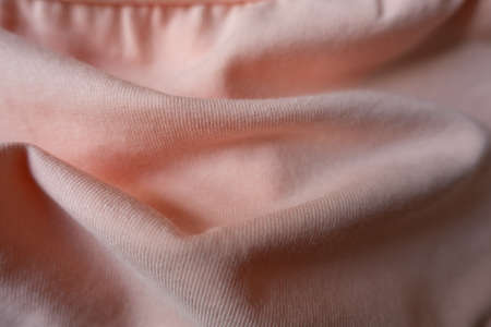 Draped pale melon pink cotton jersey fabricの写真素材