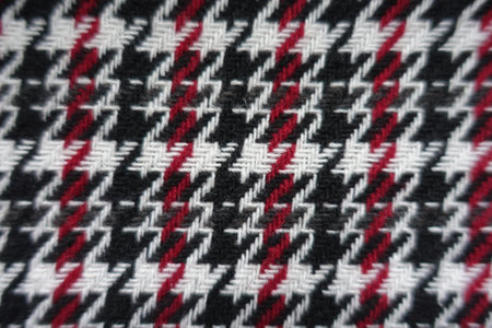 Top view of thick black, red and white woolen twill fabric