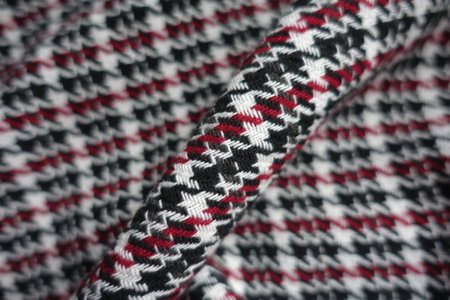 Fold on thick black, red and white woolen twill fabricの写真素材