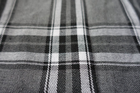 Close view of gray, black and white cotton flannel tartan fabric
