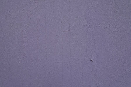 Close shot of pale lavender colored painted wall with cracksの写真素材