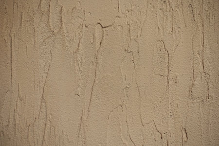 Closeup of beige wall with English stucco finish