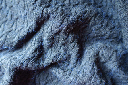 dark navy blue knitted woolen fabric in soft foldsの写真素材