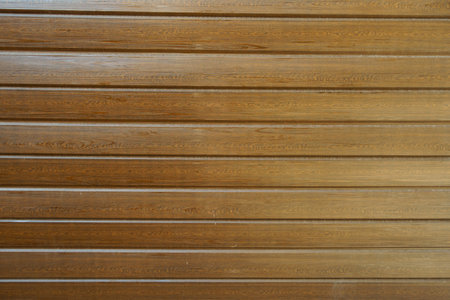 Background - brown faux wood exterior panel siding