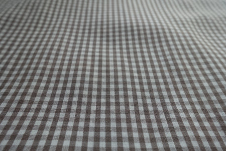 Closeup of cotton fabric with grey and white gingham pattern