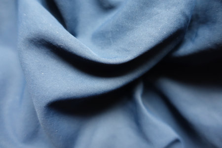 Folded thin unprinted dark blue polyester fabricの写真素材