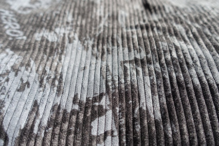 Closeup of gray corduroy fabric with abstract print