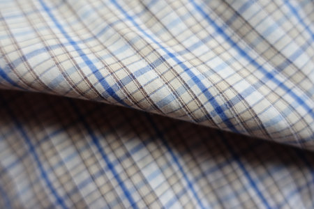 Folded white, blue and brown checkered cotton fabricの写真素材