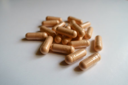 Closeup of heap of pink capsules of palmitoylethanolamide dietary supplement