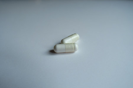 Oblong white capsules of acetyl cysteine dietary supplement (two items)の写真素材