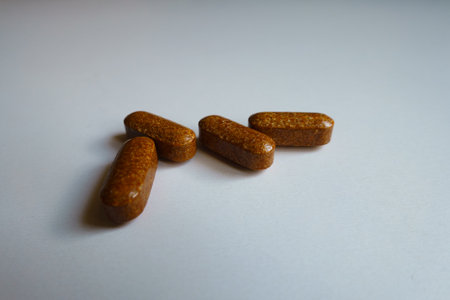 Macro of four brown caplets of iron dietary supplement