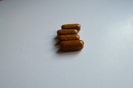 Closeup of four brown caplets of iron dietary supplementの写真素材