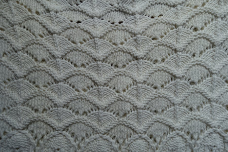 Top view of white wavy knitted lace fabric