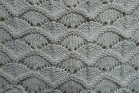 Texture of white wavy knitted lace fabric
