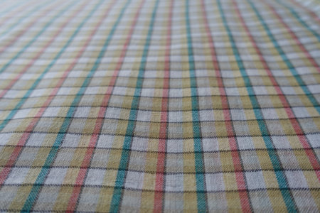 Close shot of white, yellow, red and green checkered cotton fabric