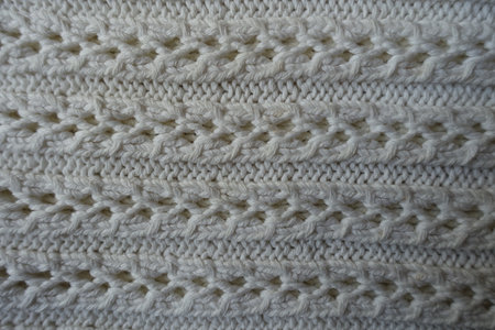 Top view of white striped handmade knitted lace fabric