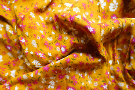 Wrinkled mustard yellow, white and pink fabric