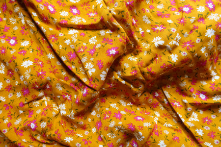 Crumpled mustard yellow, white and pink fabric