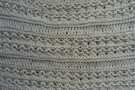 Top view of light beige handmade crochet lacy fabric