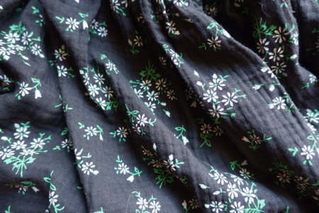 Folded black cotton muslin fabric with floral printの写真素材