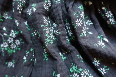 Wrinkled black cotton muslin fabric with floral printの写真素材