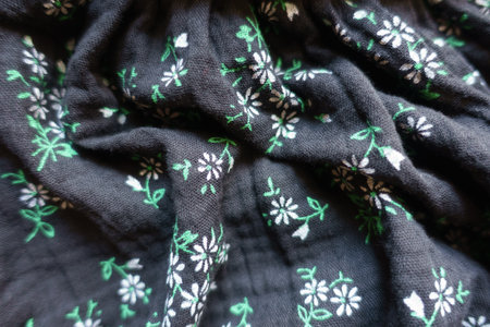 Black cotton muslin fabric with floral printの写真素材