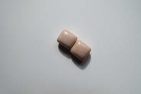 Pair of pink rectangular pieces of chewing gum from above