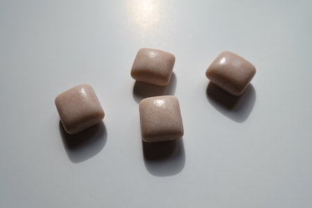 Close view of four pink rectangular pieces of chewing gumの写真素材