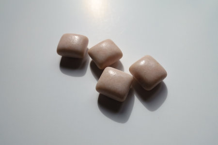 Closeup of four pink rectangular pieces of chewing gumの写真素材