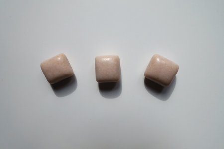 Row of three pink rectangular pieces of chewing gum