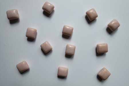 Many pink rectangular pieces of chewing gum from above