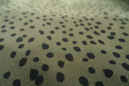 Close view of olive green and black spotted fabricの写真素材