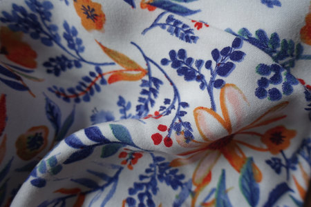 Soft fold on colorful viscose fabric with floral pattern