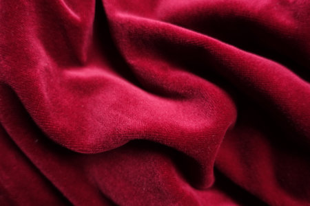 Draped deep red velour cotton fabric texture