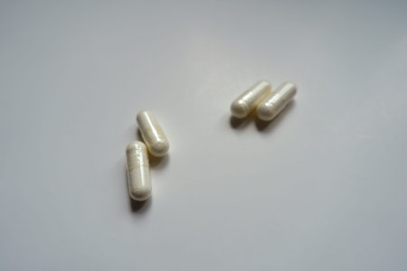 2 pairs of white capsules of melatonin dietary supplement