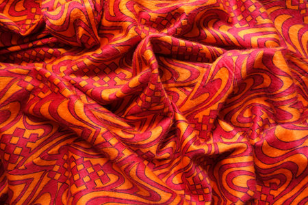 Crumpled bright red and orange pile fabric