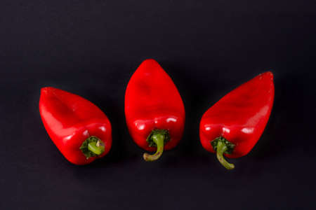 Red peppers on a black background. Ajvarの写真素材